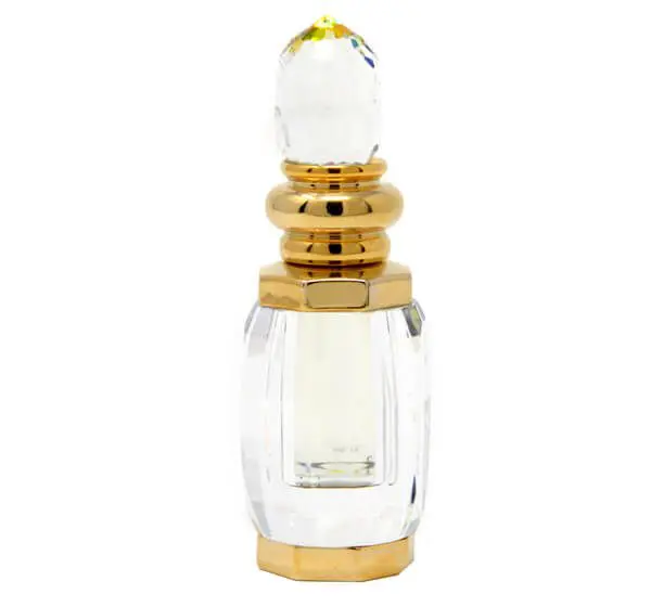 Elegant glass perfume bottle with gold accents and a clear crystal-like stopper.