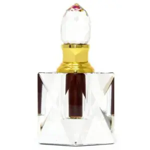 Elegant crystal perfume bottle with gold accents and a clear stopper.