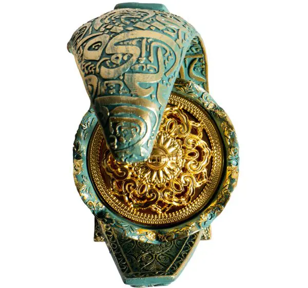 Ornate gold and turquoise decorative object.