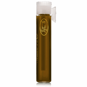 A tall glass with brown liquid and ice cubes, topped with a white lid.