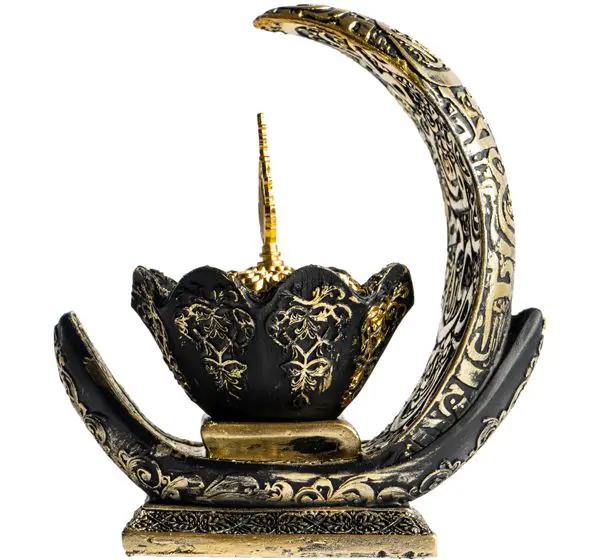 Ornate brass incense burner with crescent moon design.