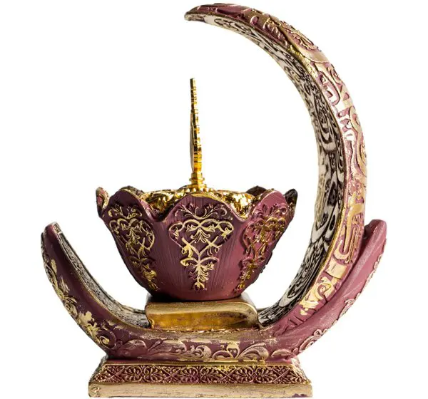 Ornate decorative incense holder with intricate gold and maroon design.
