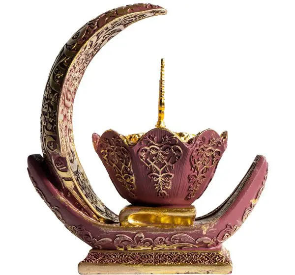 Intricately designed decorative incense holder with floral and crescent motifs.