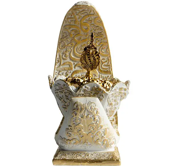 Intricately carved white stone sculpture with a tall, ornate central element.